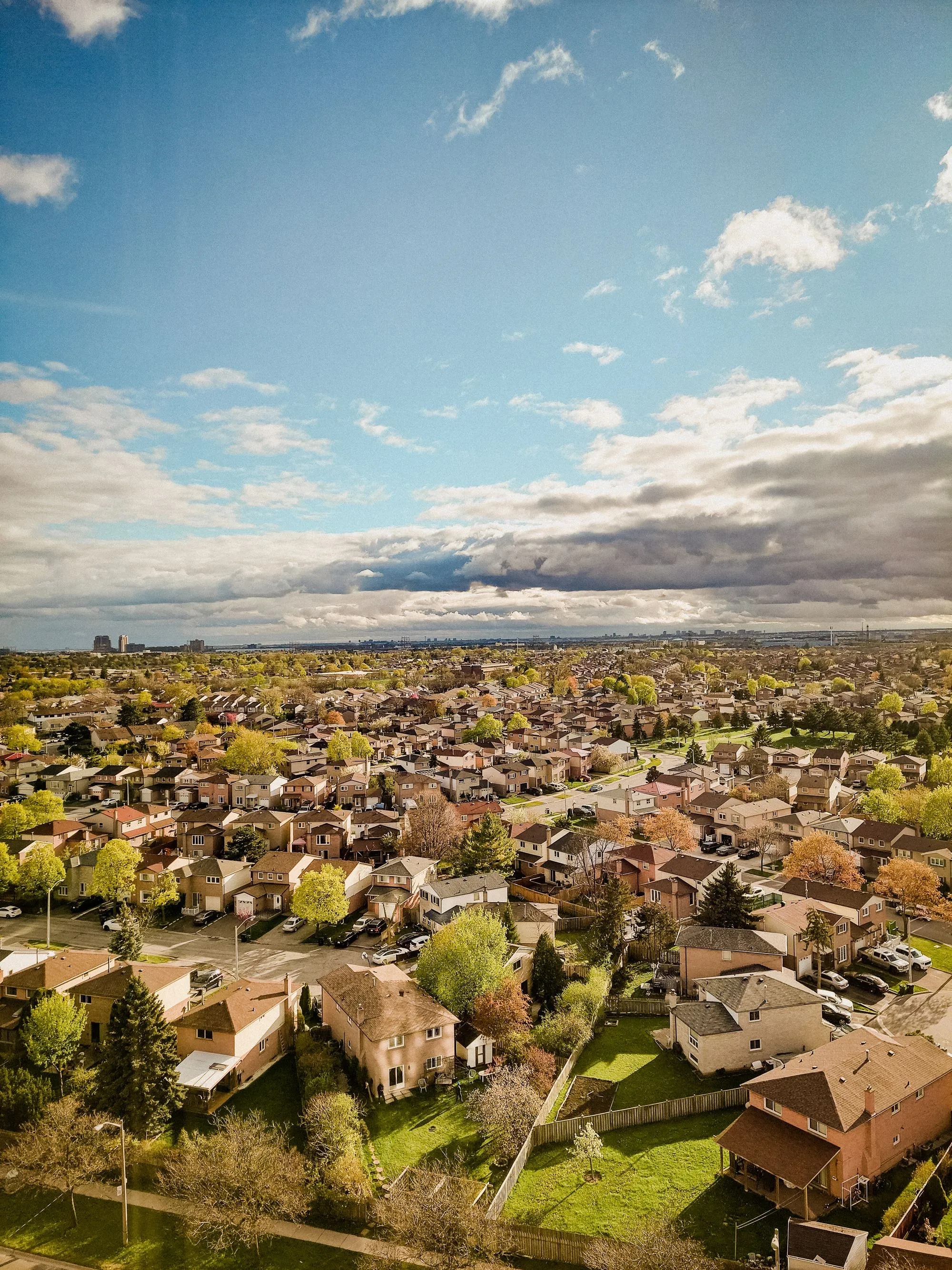A finished residential roof seen from the ground against a clear sky